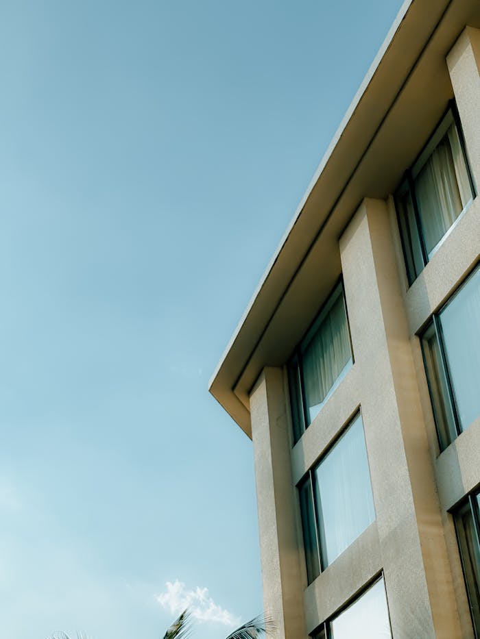 Exterior view of a modern building with blue sky, showcasing urban architecture.