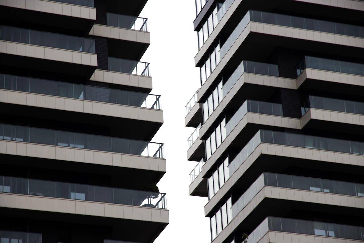 Striking architectural view of glass and metal high-rise buildings showcasing modern urban design.